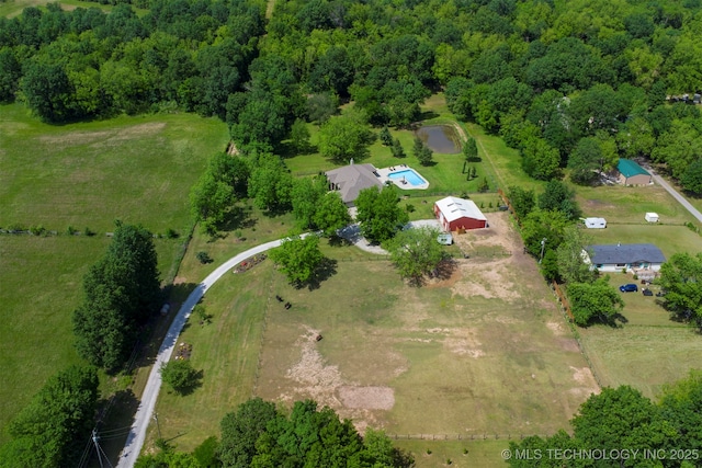 aerial overview of property's location with a heavily wooded area
