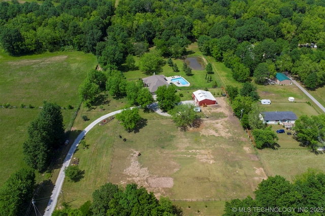 aerial overview of property's location with a heavily wooded area