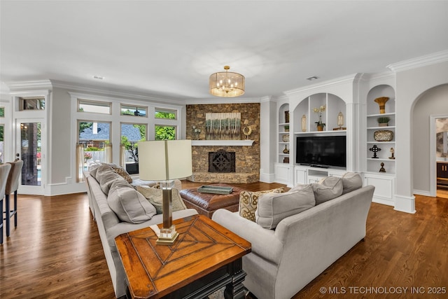 4501 E 108th Pl, Tulsa, OK 74137 - living room featuring ornamental molding, dark wood-style floors, a stone fireplace, built in shelves, and a chandelier