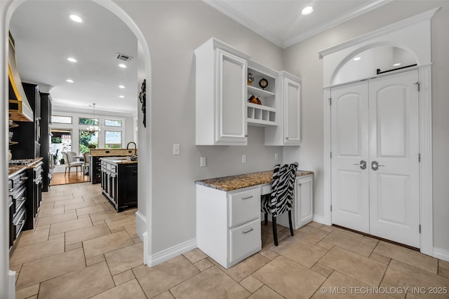 4501 E 108th Pl, Tulsa, OK 74137 - kitchen with recessed lighting, open shelves, white cabinets, baseboards, and arched walkways