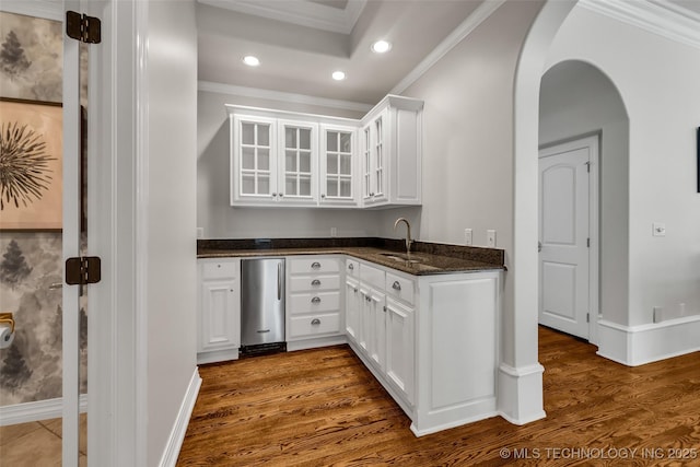 4501 E 108th Pl, Tulsa, OK 74137 - kitchen with a sink, arched walkways, recessed lighting, crown molding, and white cabinetry