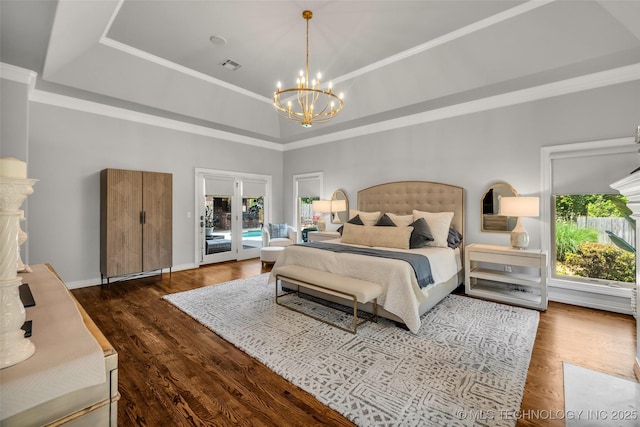 4501 E 108th Pl, Tulsa, OK 74137 - bedroom with a chandelier, multiple windows, access to outside, and wood finished floors