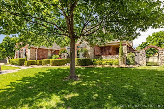 4501 E 108th Pl, Tulsa, OK 74137 - obstructed view of property with a front lawn, brick siding, and stone siding