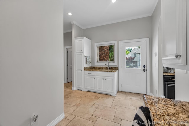 4501 E 108th Pl, Tulsa, OK 74137 - kitchen featuring a sink, white cabinetry, stone countertops, crown molding, and baseboards