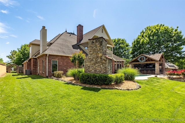 4501 E 108th Pl, Tulsa, OK 74137 - view of side of home featuring a lawn, central AC unit, a gazebo, and brick siding