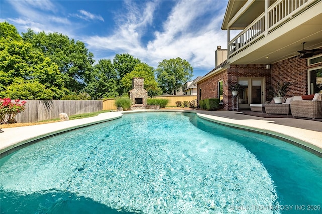 4501 E 108th Pl, Tulsa, OK 74137 - view of pool with a fenced backyard, a patio area, and an outdoor living space with a fireplace