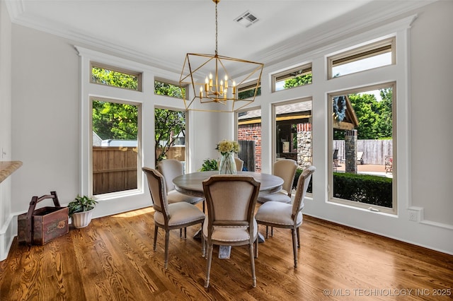4501 E 108th Pl, Tulsa, OK 74137 - dining space featuring ornamental molding, a chandelier, and wood finished floors