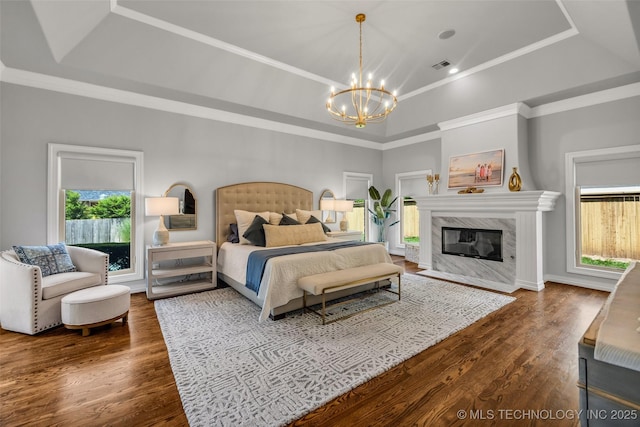 4501 E 108th Pl, Tulsa, OK 74137 - bedroom with a chandelier, wood finished floors, a raised ceiling, a fireplace, and ornamental molding