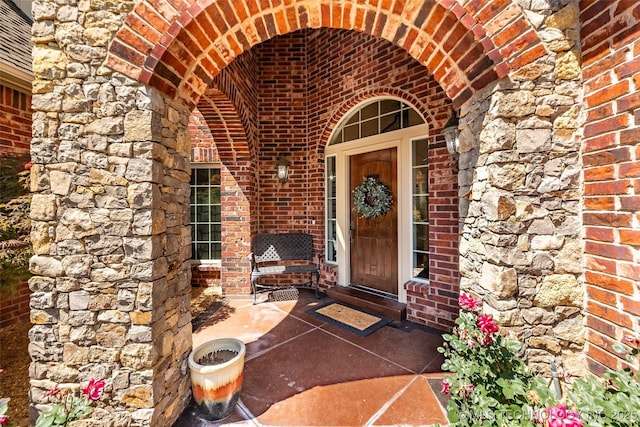 4501 E 108th Pl, Tulsa, OK 74137 - property entrance with brick siding, a patio, and stone siding