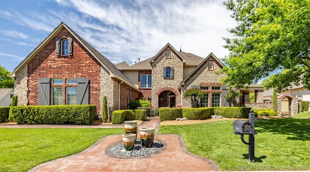 4501 E 108th Pl, Tulsa, OK 74137 - view of front of home with stone siding, a front lawn, and brick siding