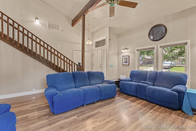 living area featuring high vaulted ceiling, stairs, wood finished floors, ceiling fan, and baseboards