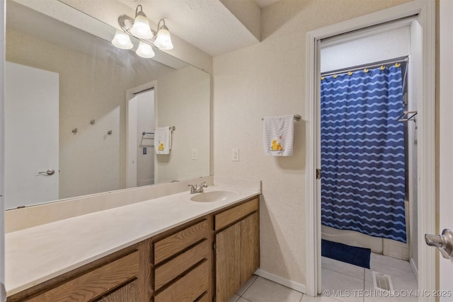 full bathroom featuring tile patterned flooring, vanity, baseboards, and curtained shower