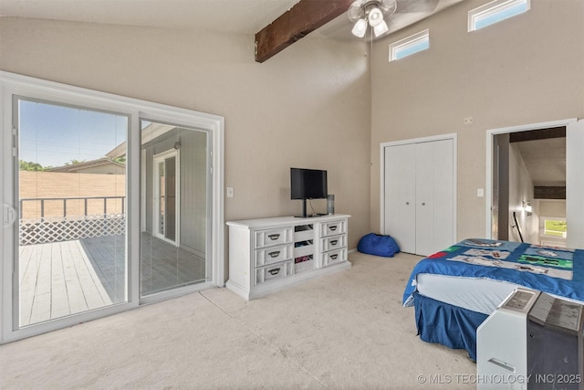 bedroom with carpet floors, access to outside, beamed ceiling, a ceiling fan, and a high ceiling