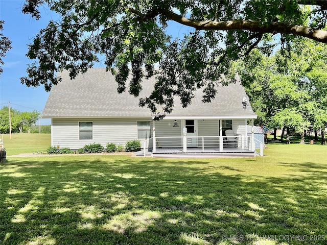 7944 Restful Ln, Kingston, OK 73439 - back of property featuring a lawn and a shingled roof