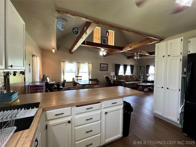 7944 Restful Ln, Kingston, OK 73439 - kitchen featuring a peninsula, ceiling fan, freestanding refrigerator, butcher block countertops, and white cabinetry