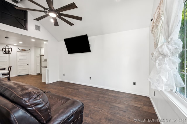 610 E 4th Ave, Bristow, OK 74010 - living room featuring a ceiling fan, healthy amount of natural light, dark wood-type flooring, baseboards, and high vaulted ceiling