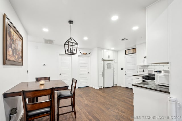 610 E 4th Ave, Bristow, OK 74010 - dining room with dark wood-type flooring and recessed lighting