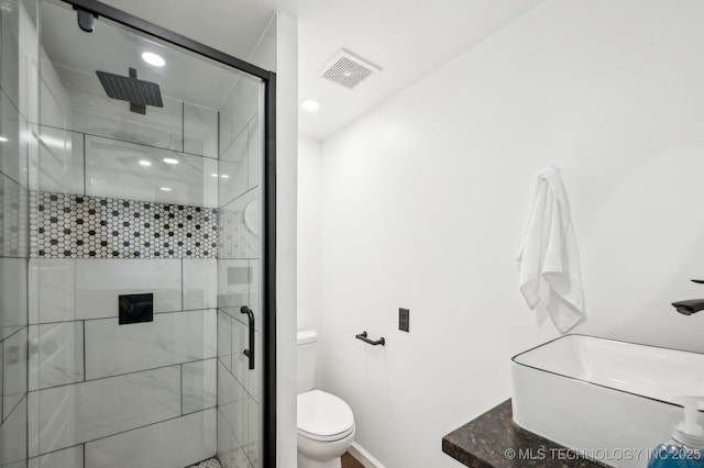 610 E 4th Ave, Bristow, OK 74010 - bathroom featuring toilet, a stall shower, baseboards, and recessed lighting