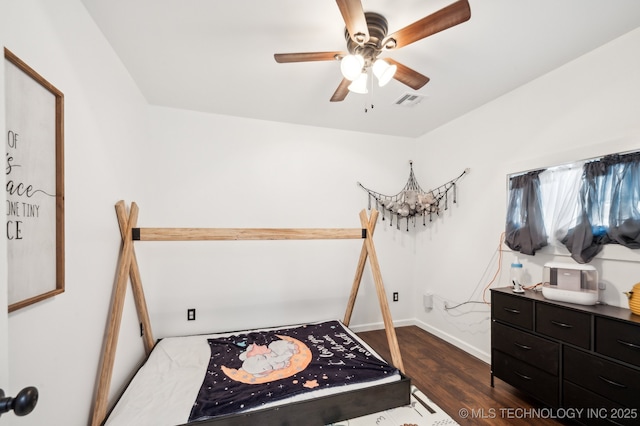 610 E 4th Ave, Bristow, OK 74010 - bedroom featuring dark wood finished floors, baseboards, and a ceiling fan
