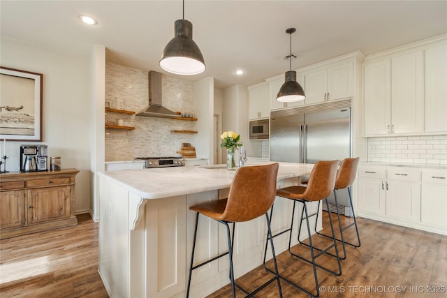 16990 S 33rd W Ave, Glenpool, OK 74033 - kitchen featuring wall chimney exhaust hood, built in appliances, tasteful backsplash, open shelves, and white cabinets