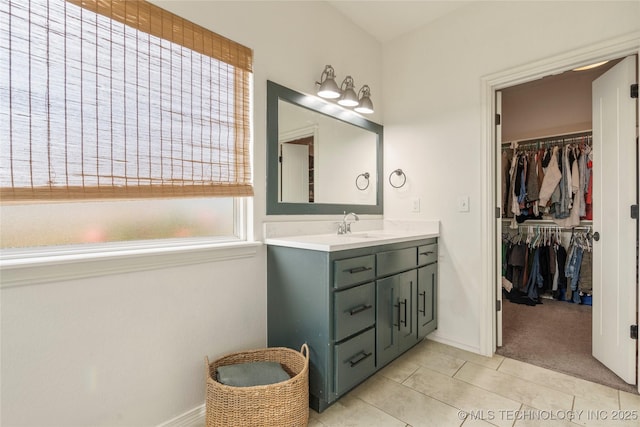 16990 S 33rd W Ave, Glenpool, OK 74033 - bathroom with vanity, a spacious closet, baseboards, and tile patterned flooring