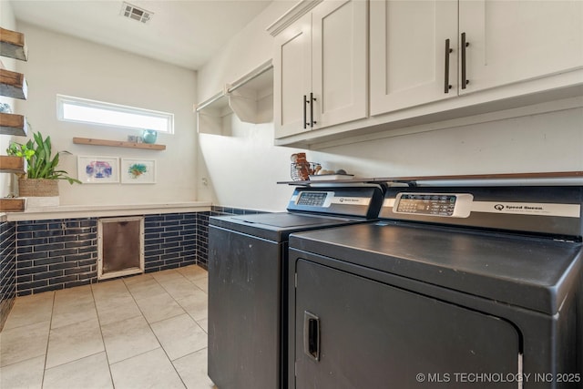 16990 S 33rd W Ave, Glenpool, OK 74033 - laundry area featuring cabinet space, independent washer and dryer, and light tile patterned flooring