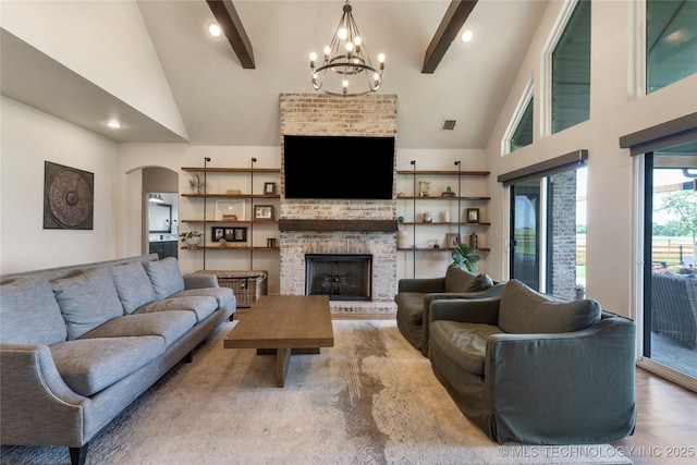 16990 S 33rd W Ave, Glenpool, OK 74033 - living area with a chandelier, a brick fireplace, arched walkways, beamed ceiling, and high vaulted ceiling