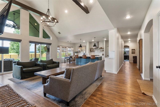16990 S 33rd W Ave, Glenpool, OK 74033 - living room featuring arched walkways, wood finished floors, high vaulted ceiling, a chandelier, and recessed lighting