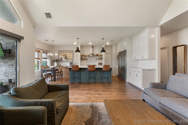 16990 S 33rd W Ave, Glenpool, OK 74033 - living room featuring wood finished floors, recessed lighting, and a chandelier