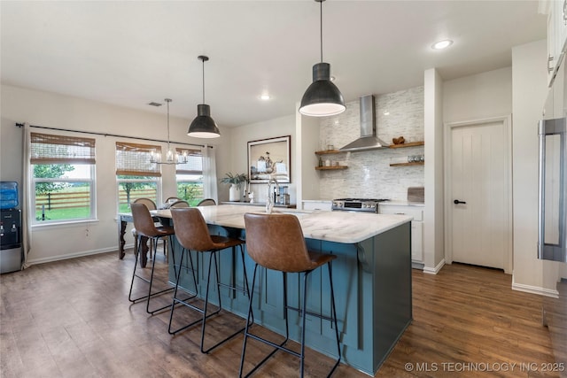 16990 S 33rd W Ave, Glenpool, OK 74033 - kitchen featuring white cabinetry, a center island with sink, open shelves, dark wood finished floors, and a breakfast bar area