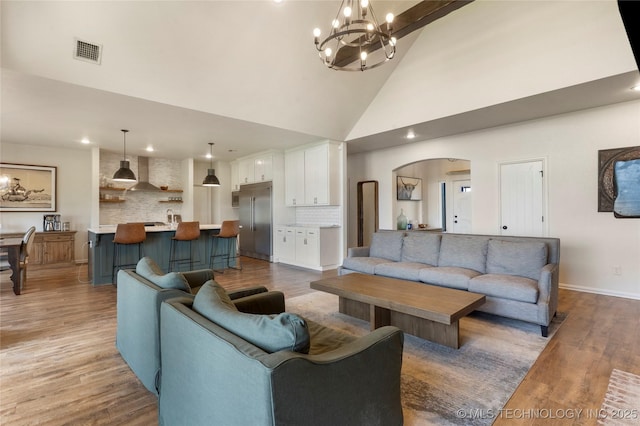 16990 S 33rd W Ave, Glenpool, OK 74033 - living room featuring arched walkways, a chandelier, high vaulted ceiling, light wood-style flooring, and recessed lighting