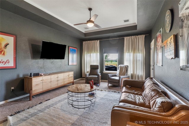 16990 S 33rd W Ave, Glenpool, OK 74033 - carpeted living area with a tray ceiling, ceiling fan, and a textured wall