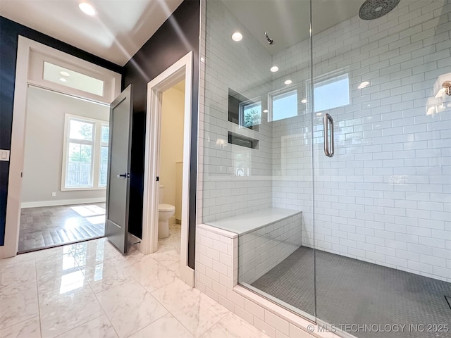 bathroom featuring toilet, a stall shower, marble finish floors, recessed lighting, and baseboards