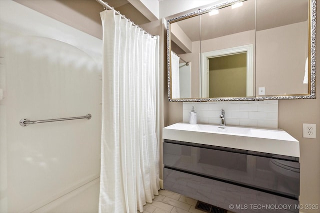 2650 S Utica Ave, Tulsa, OK 74114 - bathroom featuring decorative backsplash, vanity, and a shower with curtain