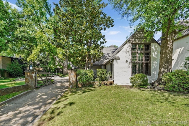 2650 S Utica Ave, Tulsa, OK 74114 - view of front of house with a front lawn, brick siding, and a shingled roof