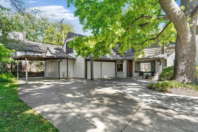 2650 S Utica Ave, Tulsa, OK 74114 - view of front of property with driveway, an attached garage, and a carport