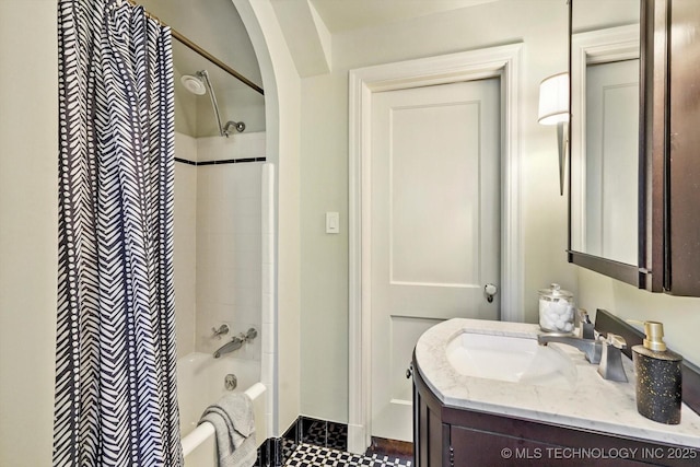 2650 S Utica Ave, Tulsa, OK 74114 - bathroom with shower / bathtub combination with curtain, vanity, and baseboards