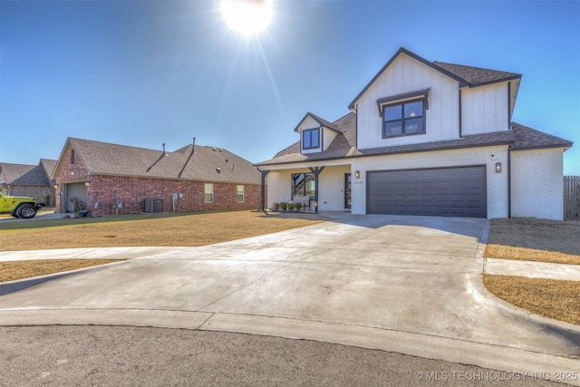 10104 S 227th E Ave, Broken Arrow, OK 74014 - view of front of property featuring brick siding, an attached garage, concrete driveway, and board and batten siding