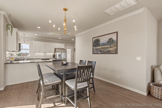 10104 S 227th E Ave, Broken Arrow, OK 74014 - dining space featuring ornamental molding, wood finished floors, a chandelier, baseboards, and recessed lighting