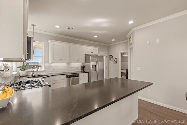 10104 S 227th E Ave, Broken Arrow, OK 74014 - kitchen with appliances with stainless steel finishes, a sink, decorative backsplash, recessed lighting, and a peninsula