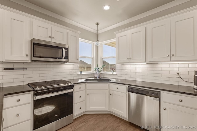 10104 S 227th E Ave, Broken Arrow, OK 74014 - kitchen with appliances with stainless steel finishes, dark countertops, a sink, white cabinets, and recessed lighting