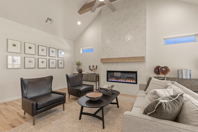 1331 N Beech St, Broken Arrow, OK 74012 - living area with high vaulted ceiling, a ceiling fan, wood finished floors, a fireplace, and beamed ceiling