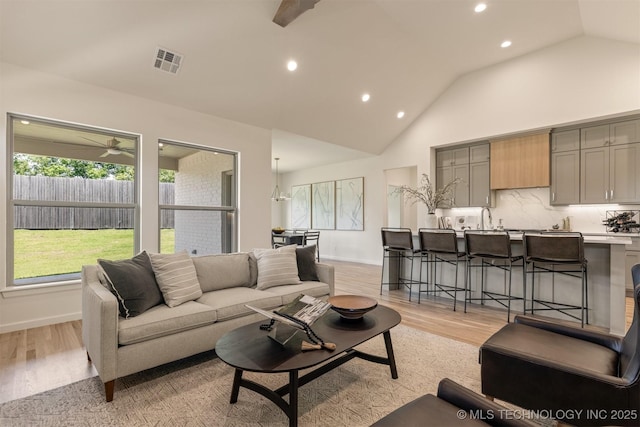 1331 N Beech St, Broken Arrow, OK 74012 - living room featuring recessed lighting, light wood finished floors, ceiling fan, high vaulted ceiling, and baseboards