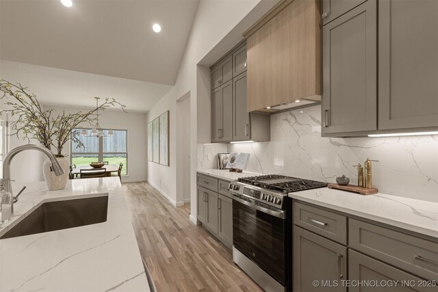 1331 N Beech St, Broken Arrow, OK 74012 - kitchen with stainless steel gas range, gray cabinetry, a sink, decorative backsplash, and light stone countertops