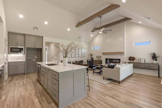 1331 N Beech St, Broken Arrow, OK 74012 - kitchen with gray cabinetry, a sink, stainless steel appliances, high vaulted ceiling, and light wood-style floors