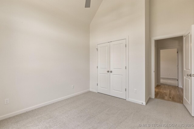 1331 N Beech St, Broken Arrow, OK 74012 - unfurnished bedroom with carpet floors, high vaulted ceiling, baseboards, and a closet