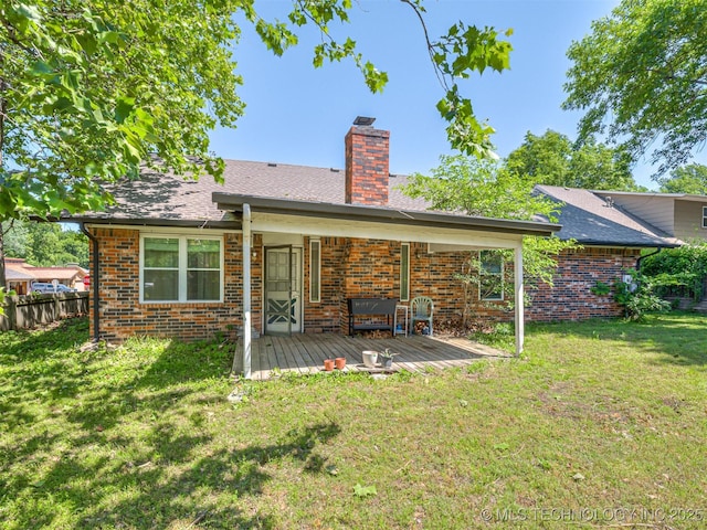 back of property with brick siding and a chimney