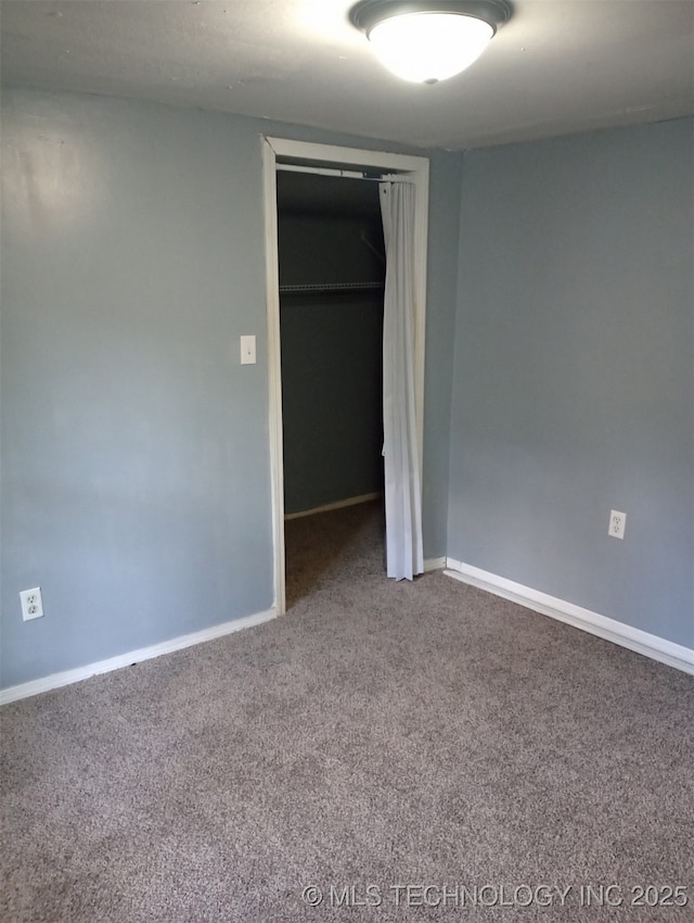 unfurnished bedroom featuring carpet floors, a closet, and baseboards