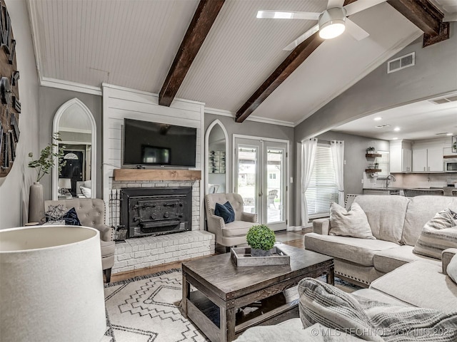 living area featuring a ceiling fan and a brick fireplace