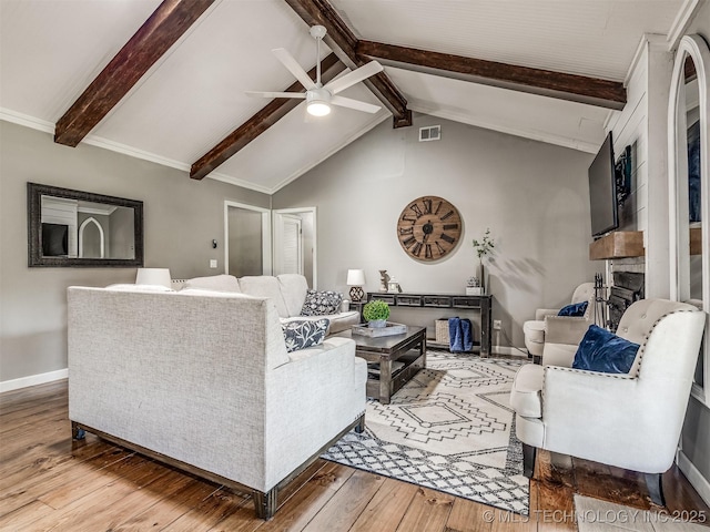 living area featuring a ceiling fan, hardwood / wood-style flooring, baseboards, and a fireplace